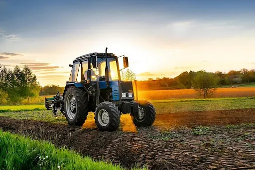 a tractor in a field being used for agricultural solutions